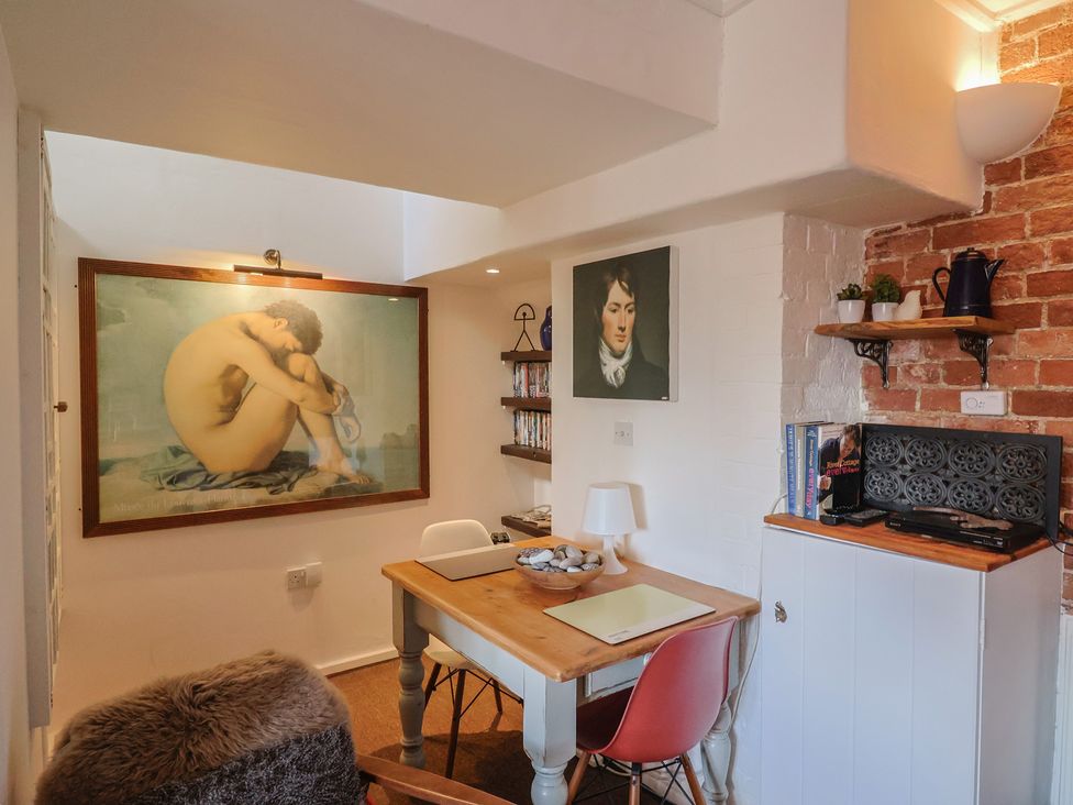 A study room with a desk and shelves at The Clock Tower Rousdon, Nr Lyme Regis