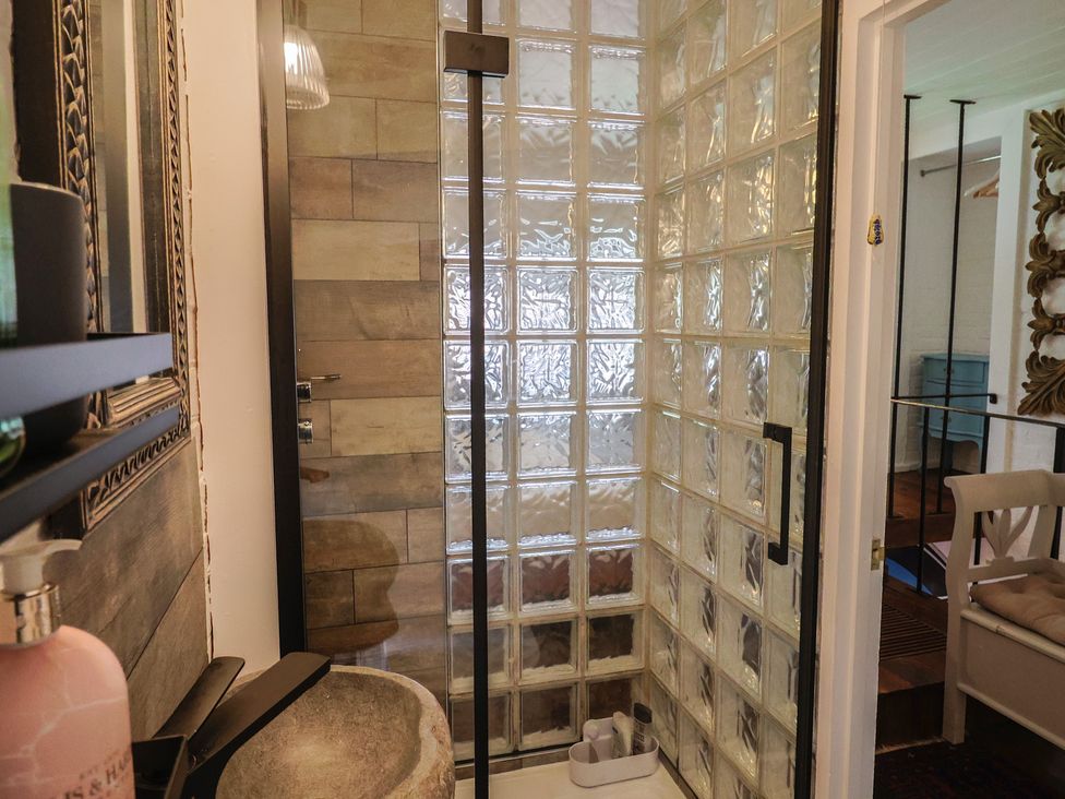 A bathroom with a shower and sink at The Clock Tower in Rousdon, Nr Lyme Regis