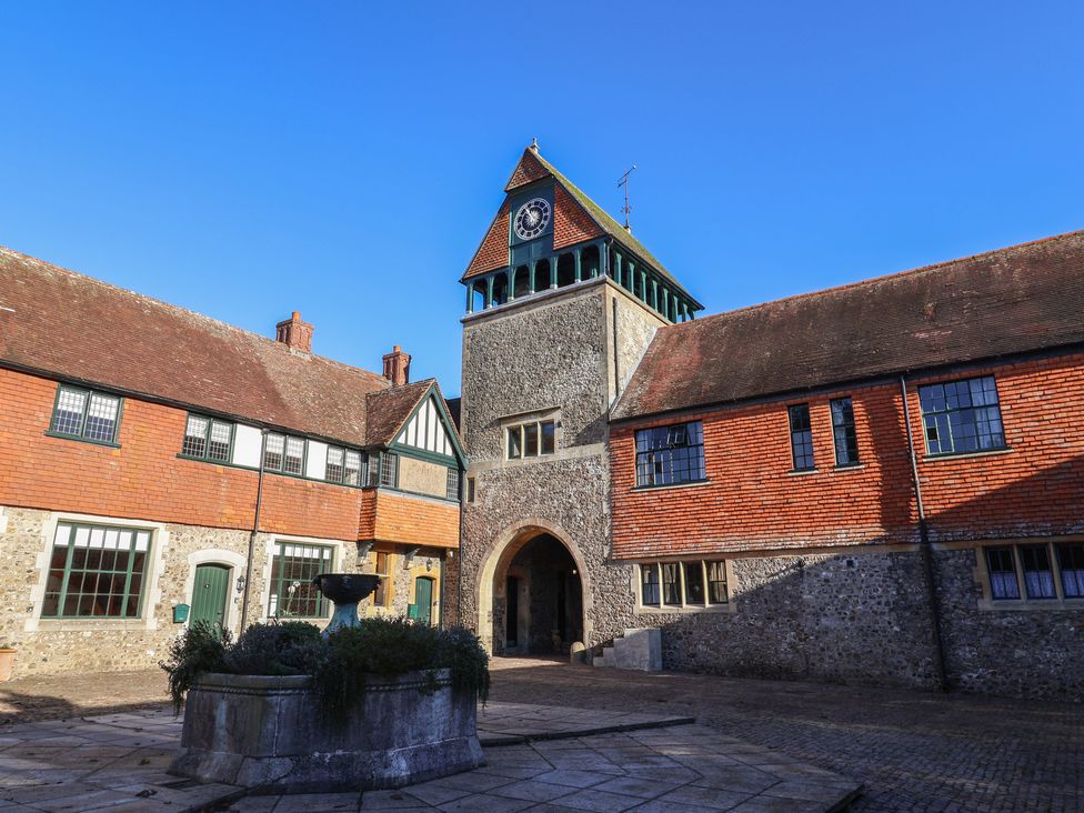 A courtyard with a clock tower and fountain at The Clock Tower in Rousdon, Nr Lyme Regis
