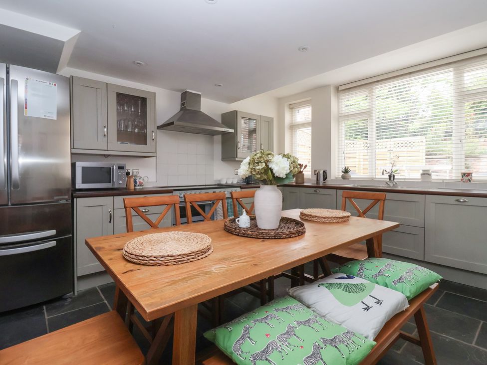 A kitchen with a dining table and chairs at Pear Tree Cottage Great Ouseburn