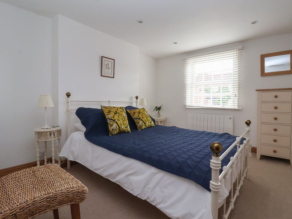 A bedroom with a bed and chest of drawers at Pear Tree Cottage in Great Ouseburn