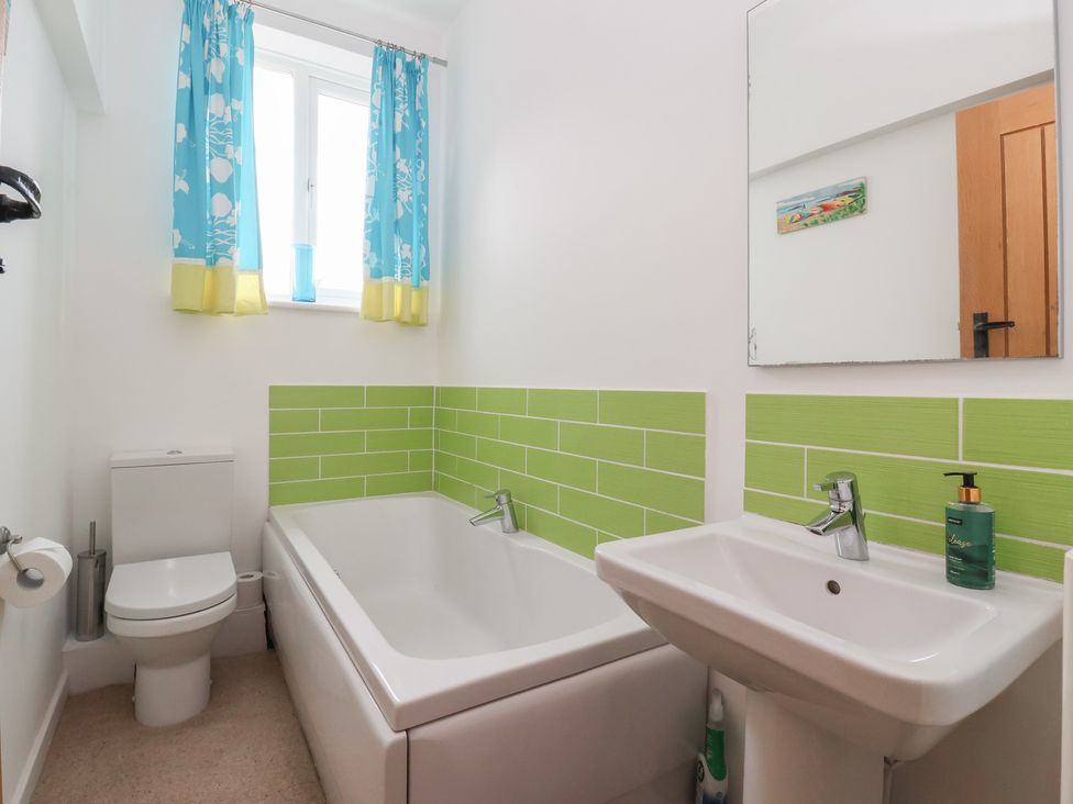 A bathroom with a bathtub and toilet at Pear Tree Cottage in Great Ouseburn