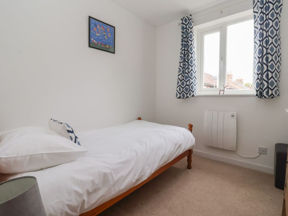 A bedroom with a bed and window at Pear Tree Cottage Great Ouseburn