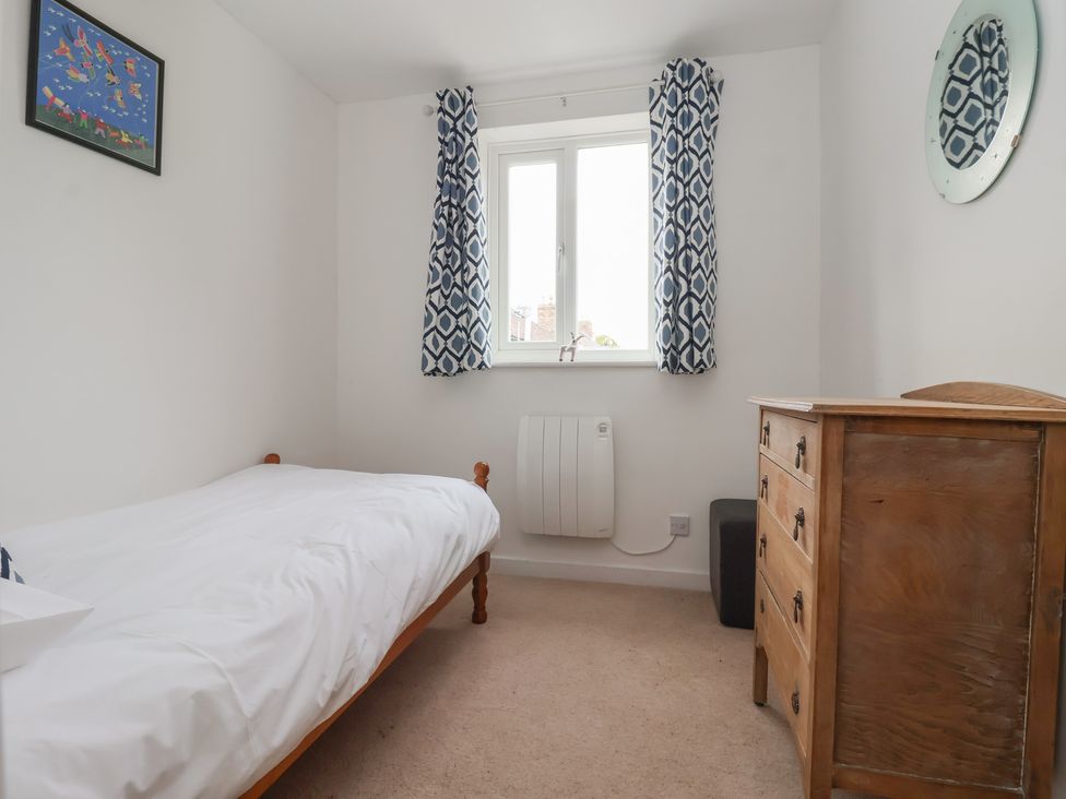 A bedroom with a bed and drawer unit at Pear Tree Cottage in Great Ouseburn