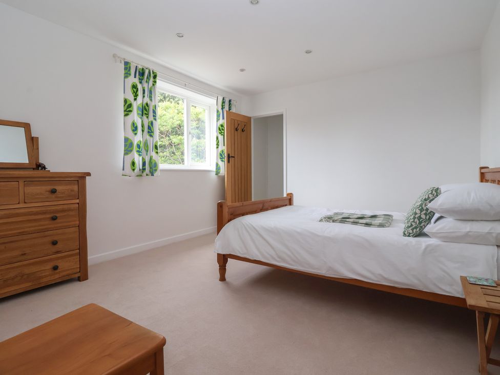 A bedroom with a bed and chest of drawers at Pear Tree Cottage Great Ouseburn