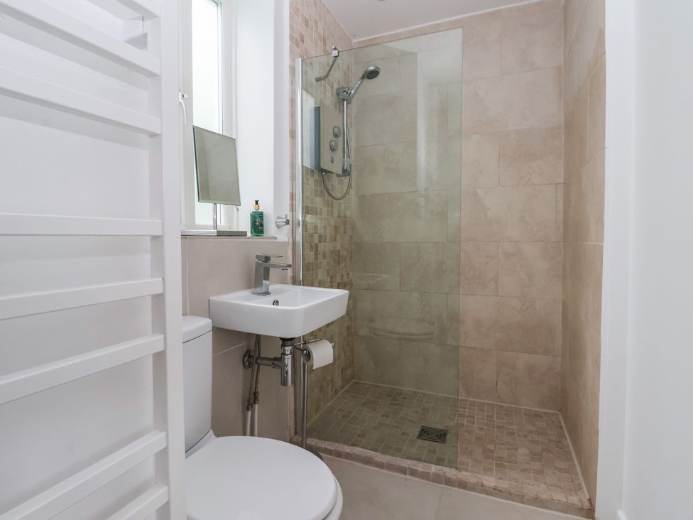 A bathroom with a shower and sink at Pear Tree Cottage in Great Ouseburn