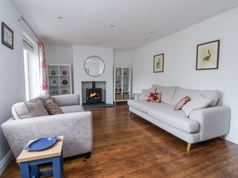 A living room with a fireplace and seating area at Pear Tree Cottage in Great Ouseburn