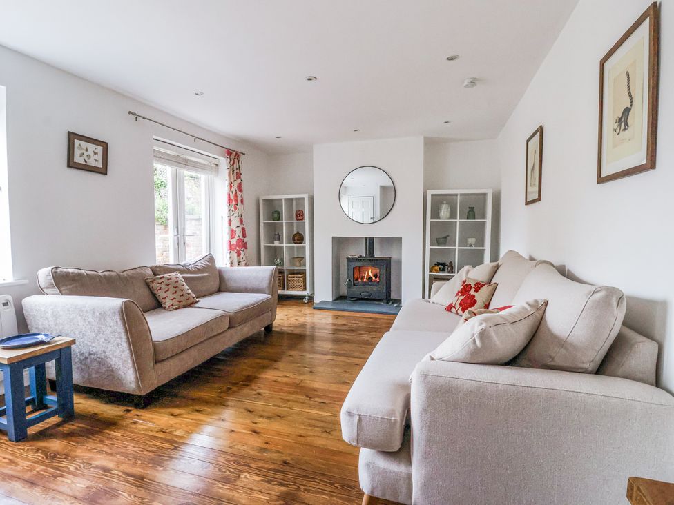 A living room with two sofas and a fireplace at Pear Tree Cottage in Great Ouseburn