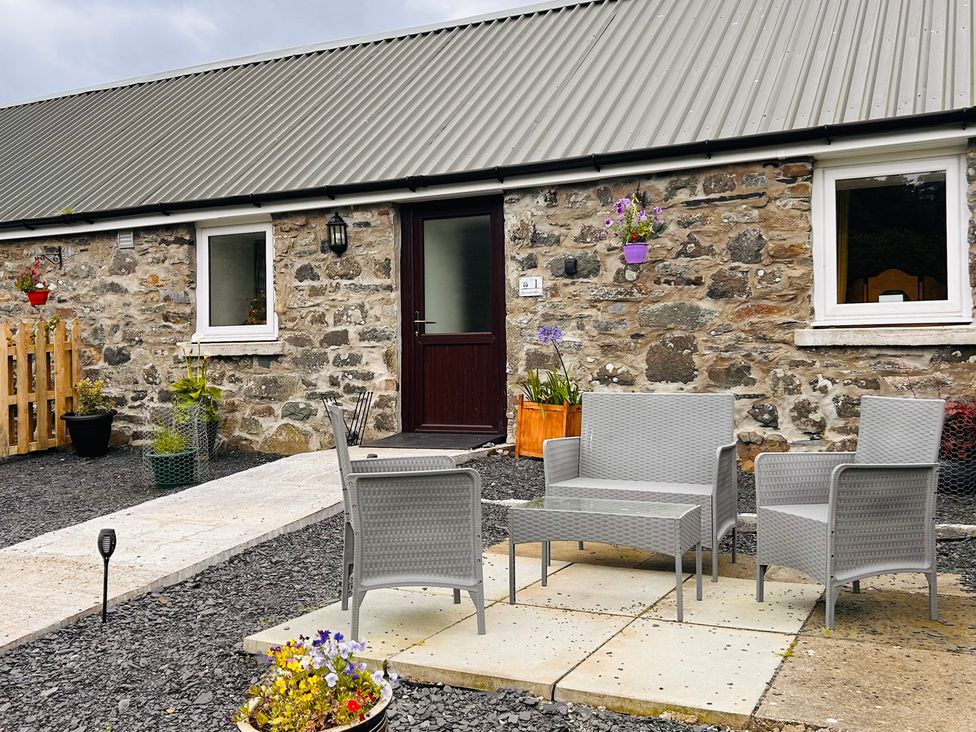 An outdoor area with seating and plants at Bathach Mor in Balvicar, Isle Of Seil
