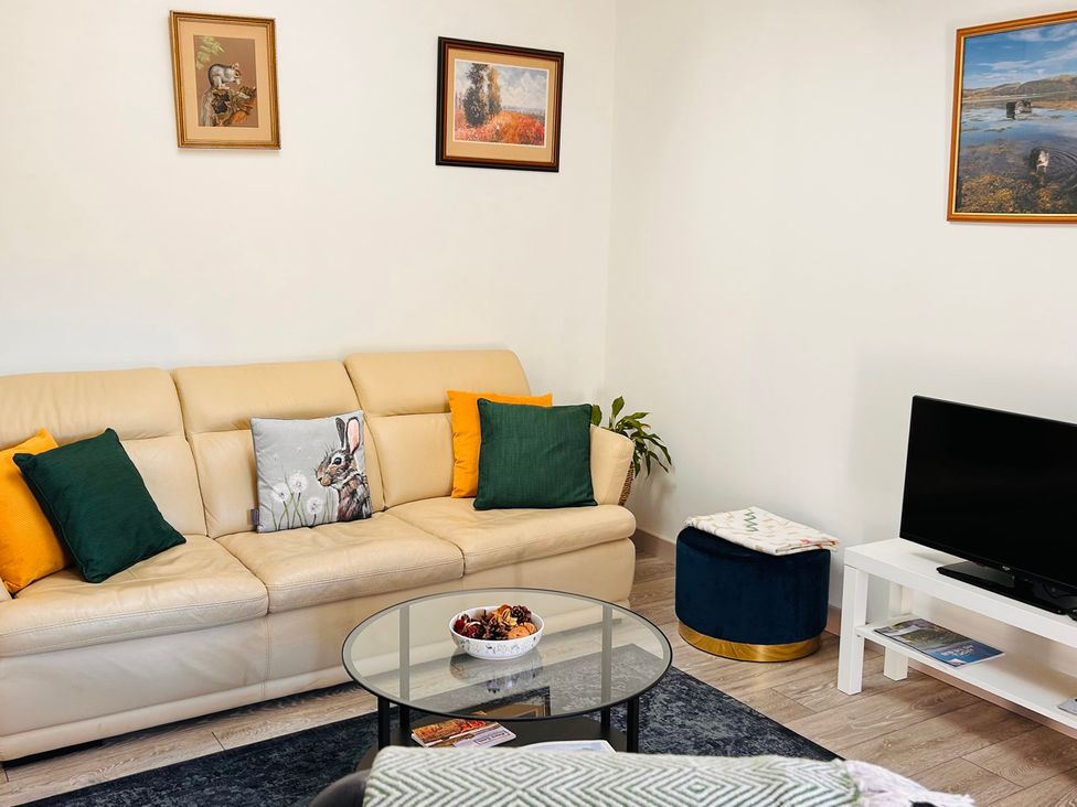 A living room with a sofa and coffee table at Bathach Mor, Balvicar, Isle Of Seil