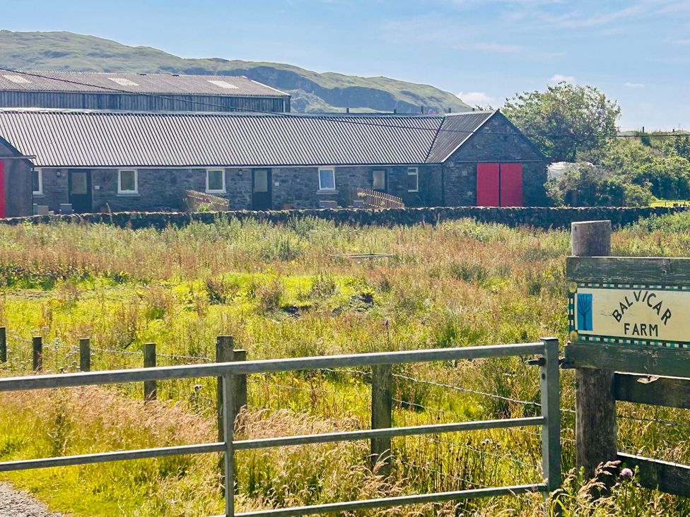 A farmhouse with a sign at Balvicar Farm in Balvicar, Isle Of Seil
