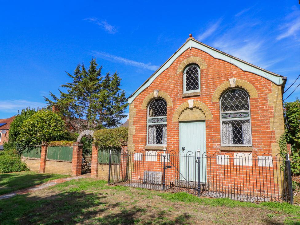 A brick building with windows and a gate at The Chapel in Northwood, Isle Of Wight