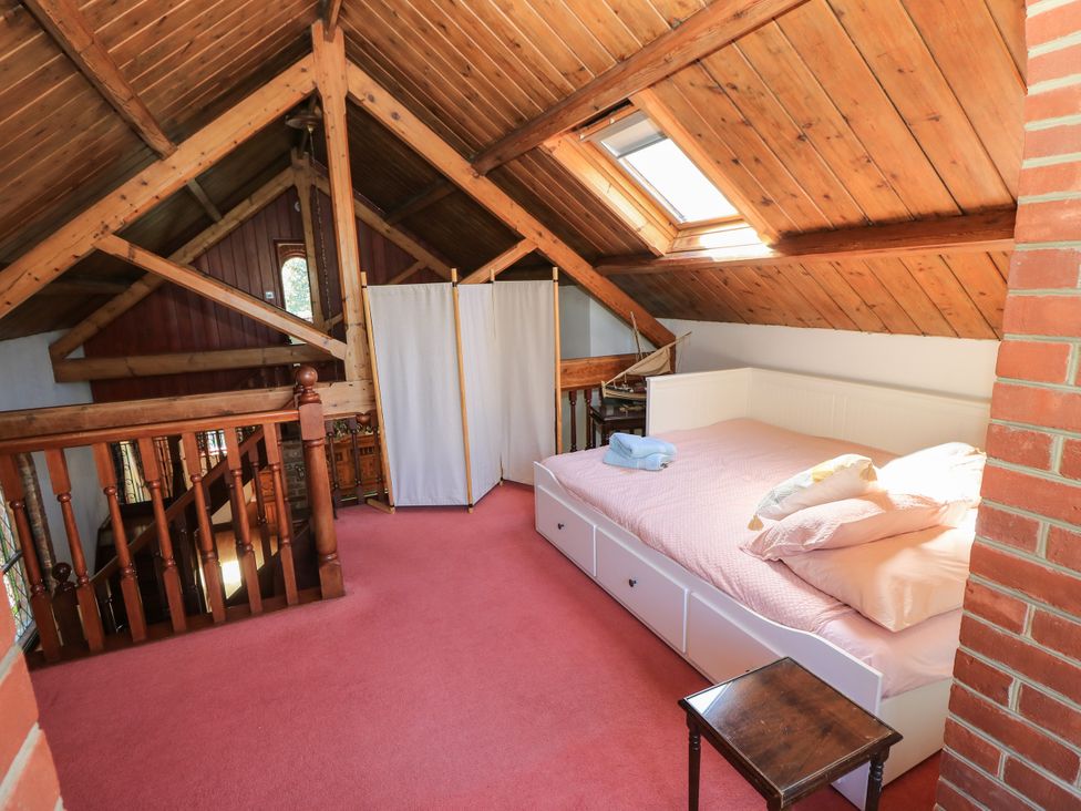 A bedroom with a bed and curtains at The Chapel in Northwood, Isle Of Wight