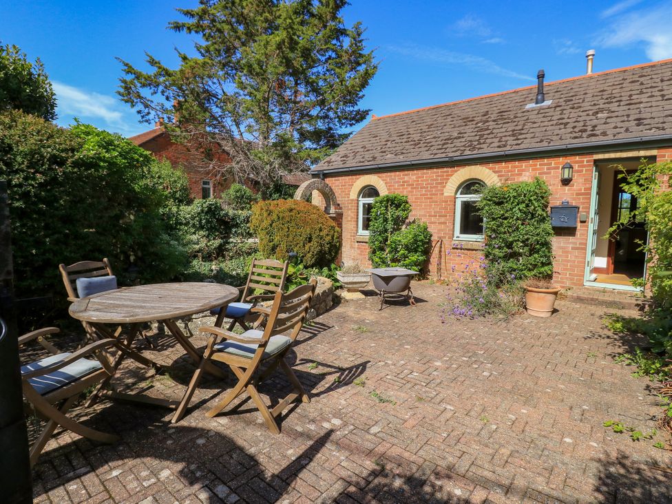 An outdoor garden area with table and chairs at The Chapel in Northwood, Isle Of Wight