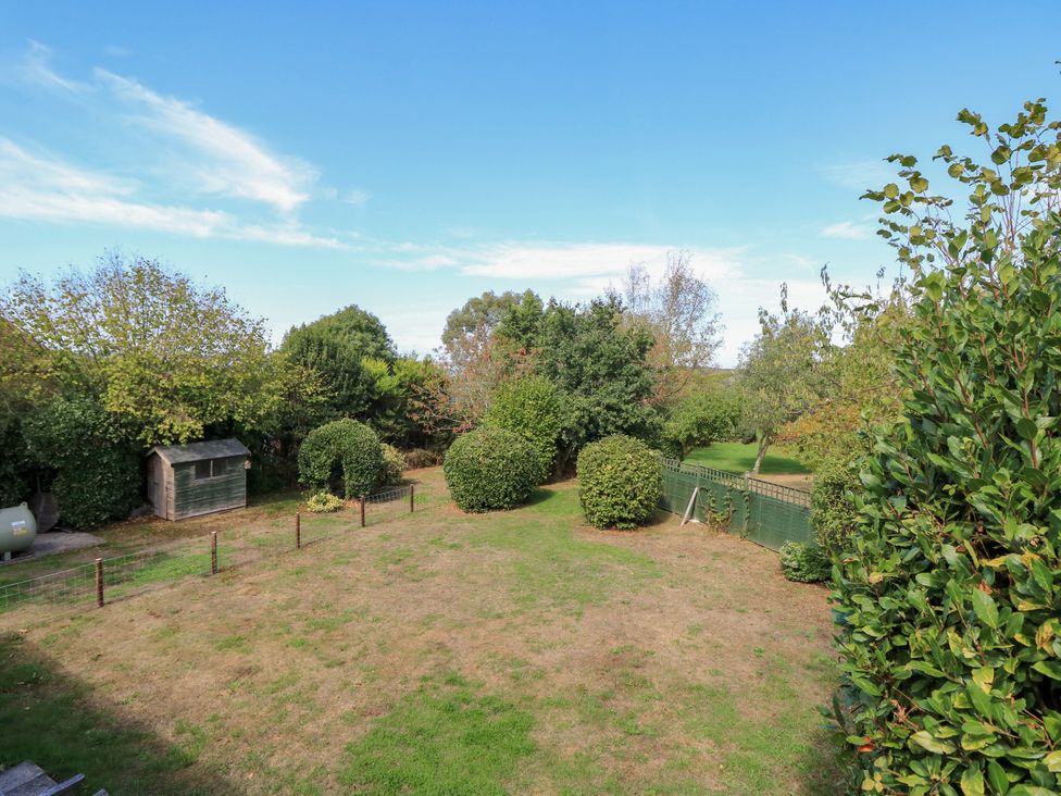 A garden with a shed and bushes at The Chapel in Northwood, Isle Of Wight