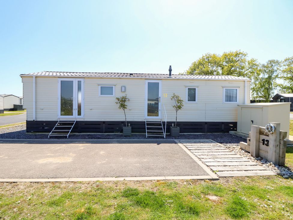 A mobile home with window and door at MillRythe Holiday Park (Dunlin Walk 13) Hayling Island