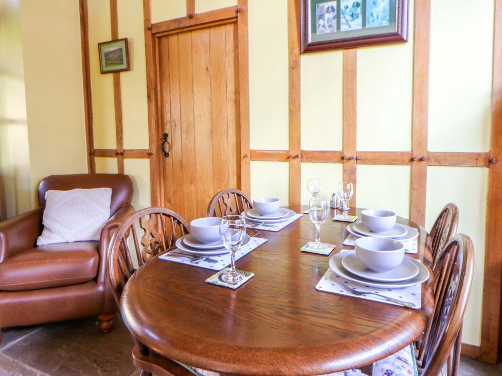 A dining room with a table set for dinner at Maggie's Barn in Brecon