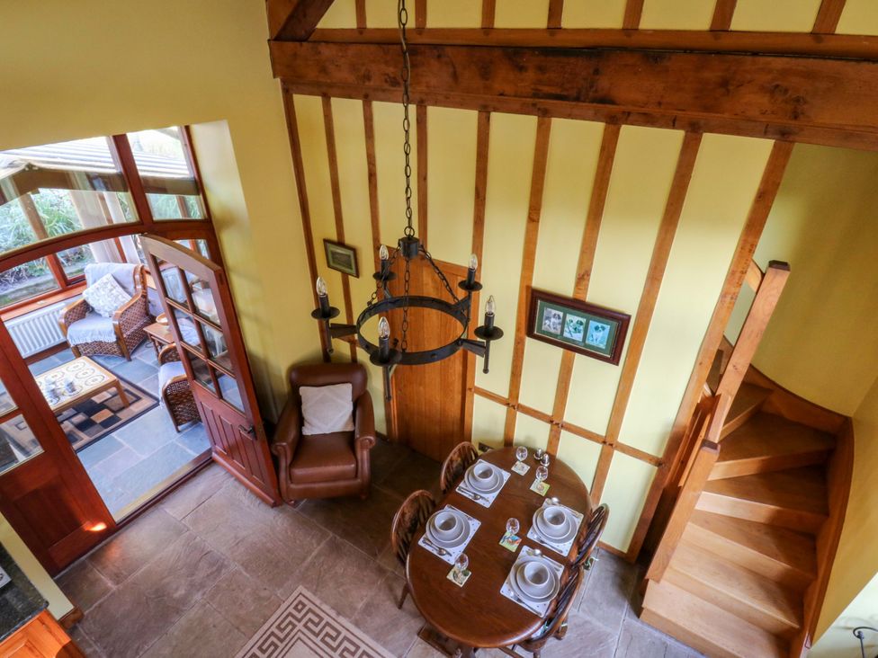 A dining room with a table and chairs at Maggie's Barn Brecon