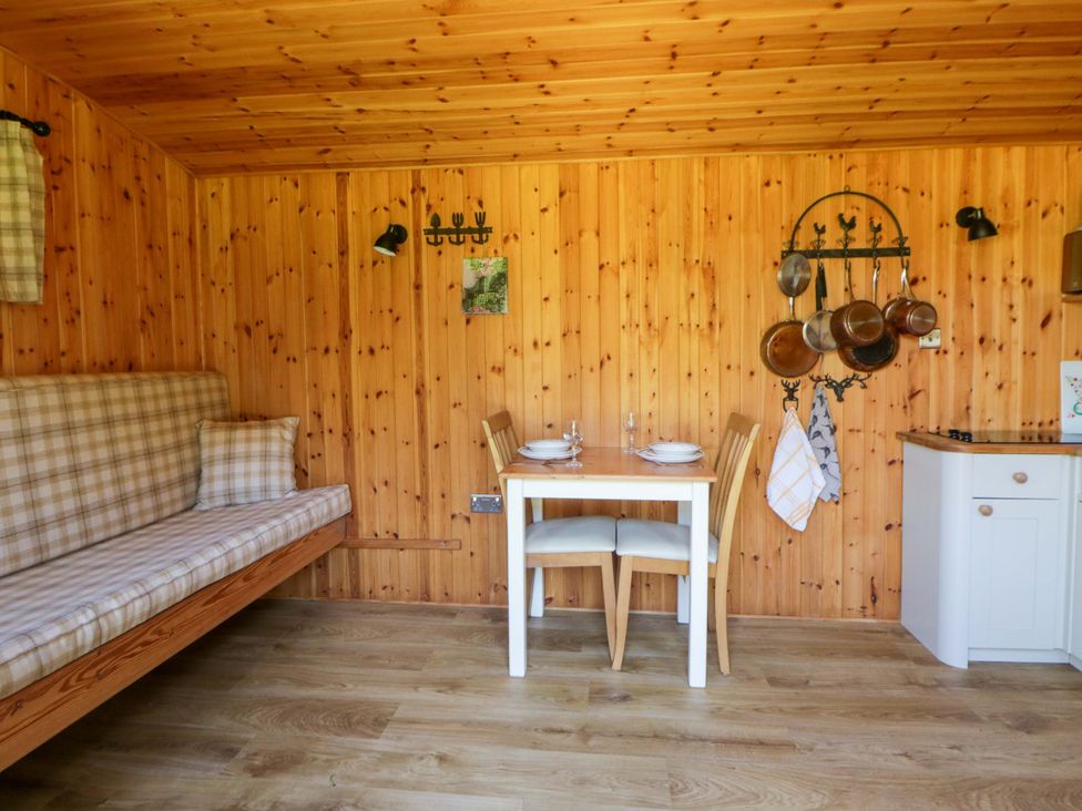 A kitchen with a table and chairs at Bill’s Shepherds Hut near Talgarth