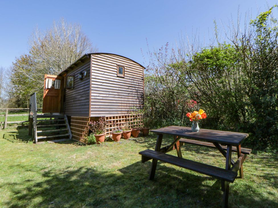 A shepherd's hut with a table and flowers near Talgarth