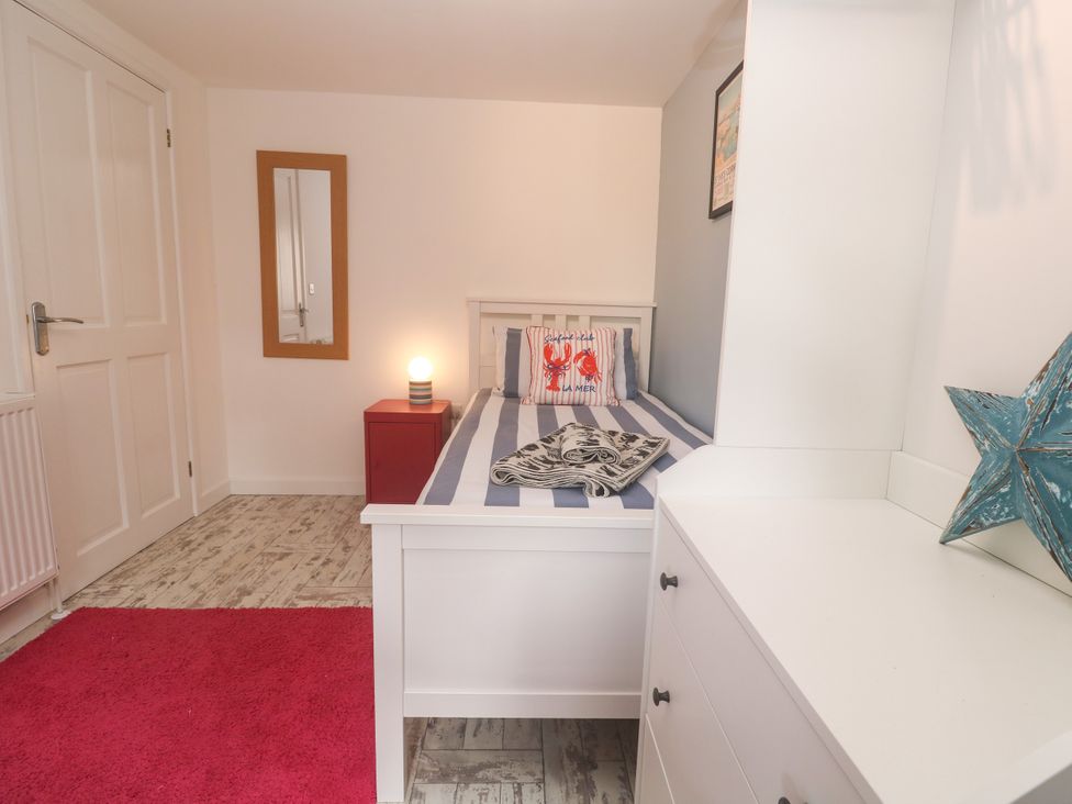 A bedroom featuring a bed with pillows and blanket at The Packing House in Rosudgeon