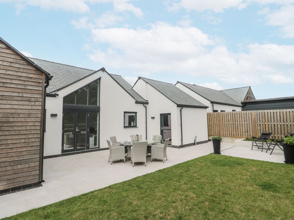 An outdoor area with seating and a patio at Kerrek Lodge in Mylor Bridge