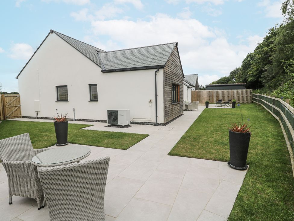 An outdoor area with a house and patio furniture at Kerrek Lodge Mylor Bridge
