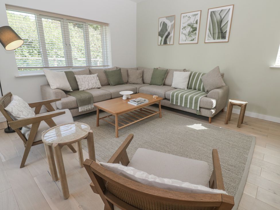 A living room with a sofa and coffee table at Kerrek Lodge in Mylor Bridge