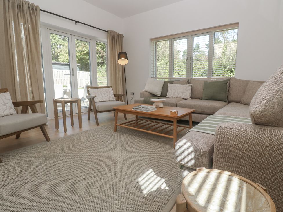 A living room with a sofa and coffee table at Kerrek Lodge in Mylor Bridge