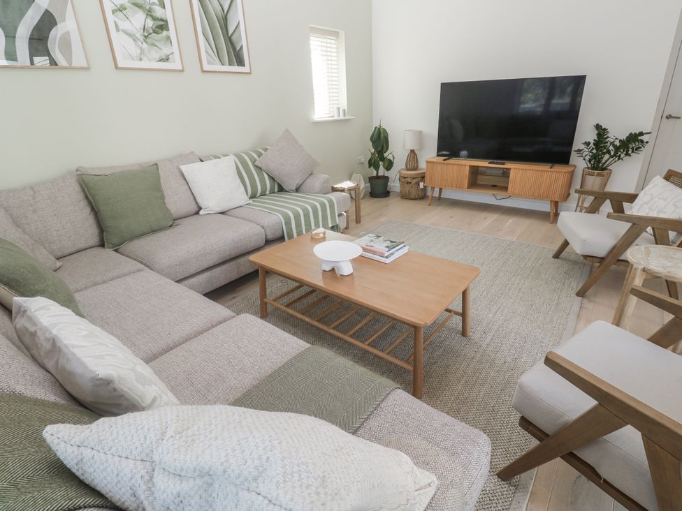 A living room with a sofa and coffee table at Kerrek Lodge in Mylor Bridge