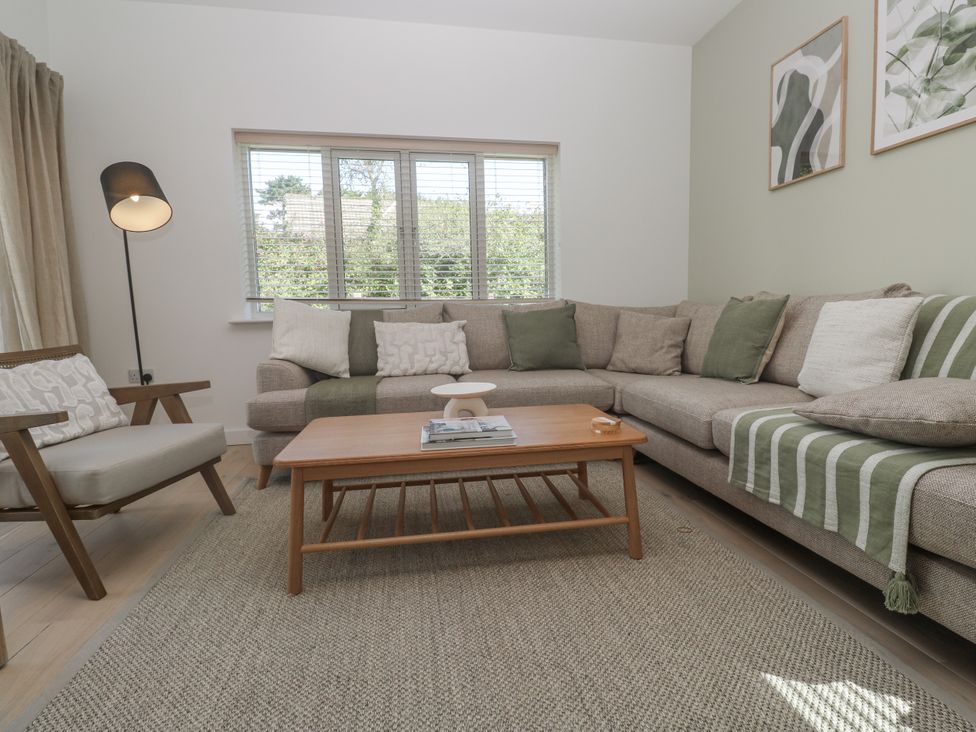 A living room with a sofa and coffee table at Kerrek Lodge Mylor Bridge