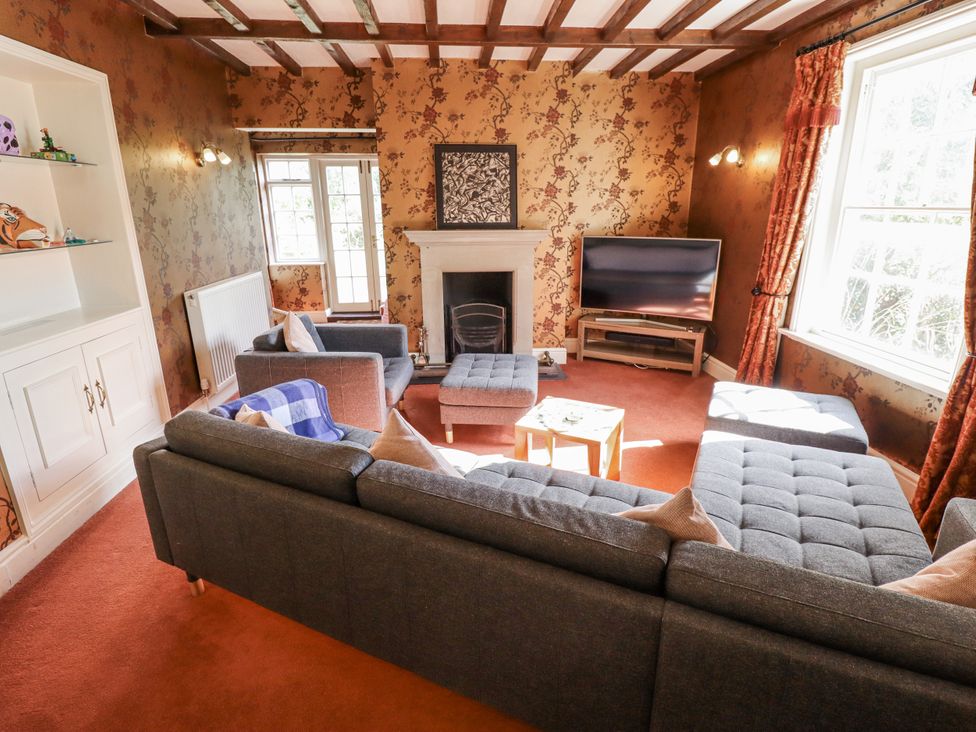 A living room with a sofa and a television at Holme Farm in Ruskington