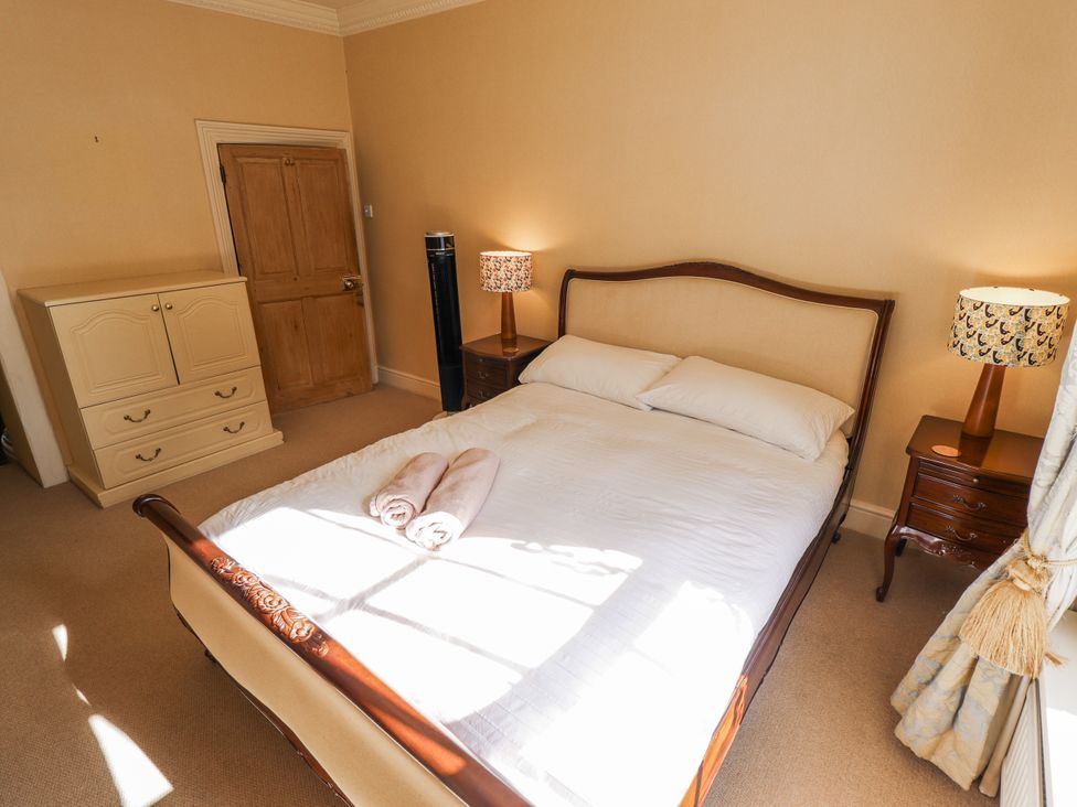 A bedroom with a bed and two towels at Holme Farm in Ruskington