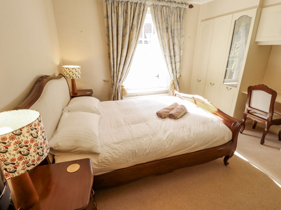 A bedroom with a bed and nightstand at Holme Farm in Ruskington