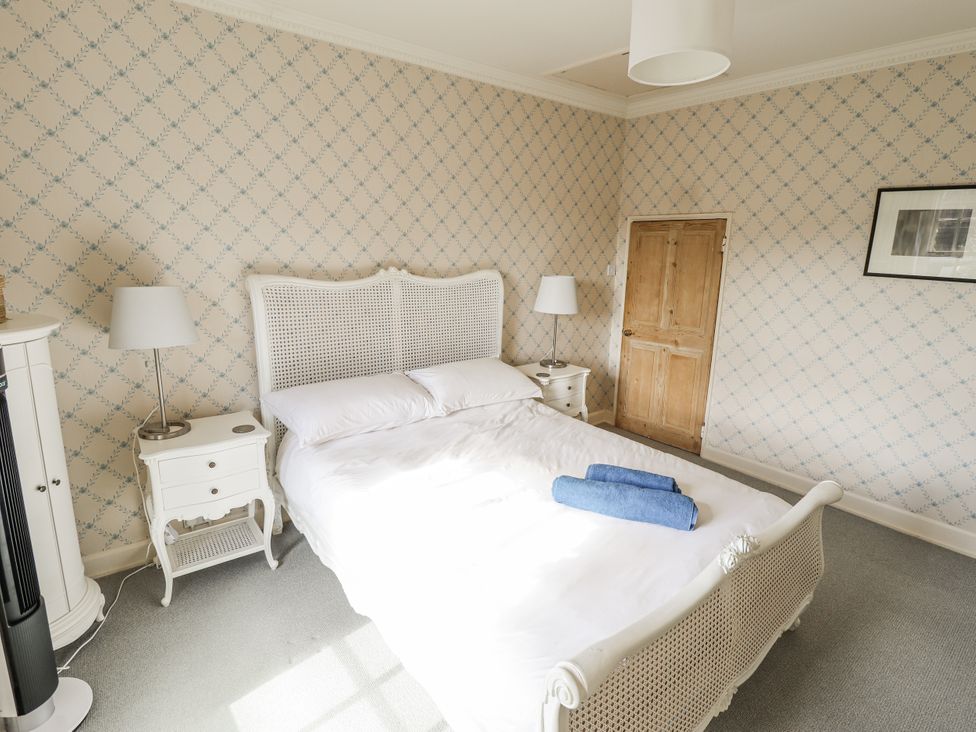 A bedroom with a bed and bedside table at Holme Farm in Ruskington