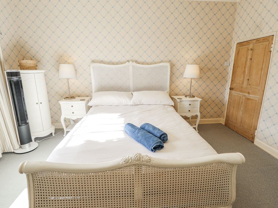 A bedroom with a bed and nightstands at Holme Farm in Ruskington