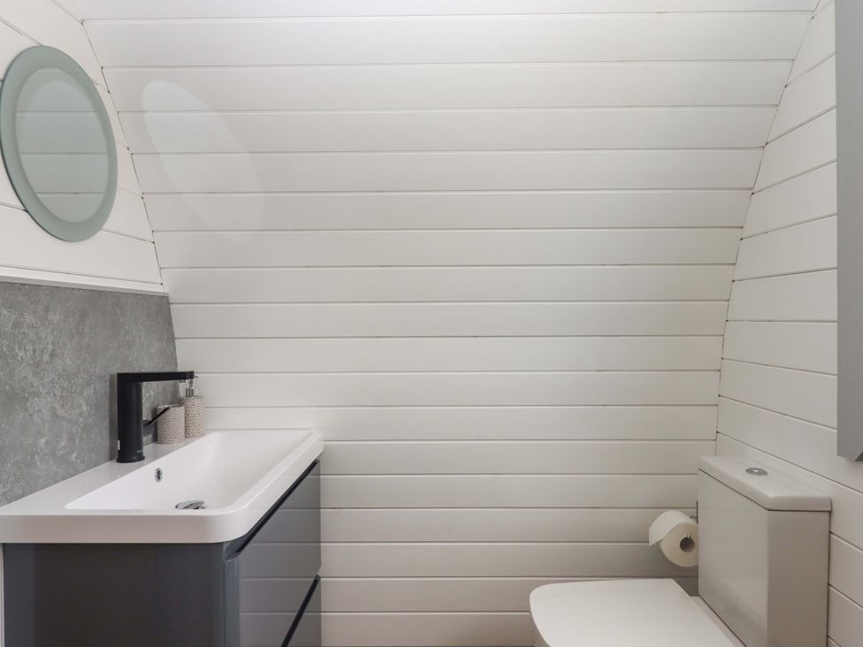 A bathroom with a sink and toilet at Under Oak Pod Totnes