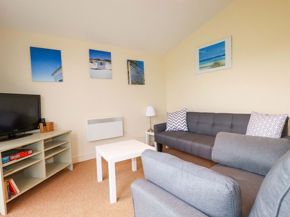 A living room with a television and sofas at 161 Atlantic Bay Holiday Park, Padstow