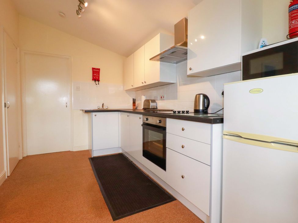 A kitchen with a fridge and oven at 161 Atlantic Bay Holiday Park in Padstow