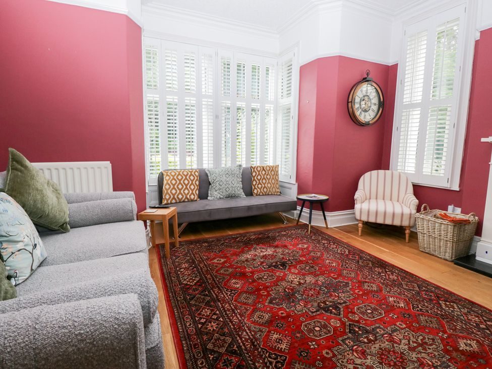 A living room with a sofa and an armchair at Sunnycroft in Keswick