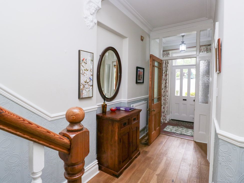 A hallway with a mirror and a wooden table at Sunnycroft in Keswick