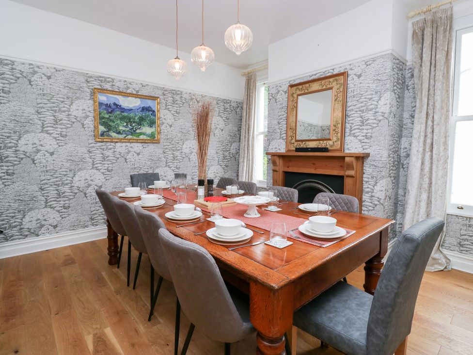 A dining room with a large table set for meals at Sunnycroft in Keswick