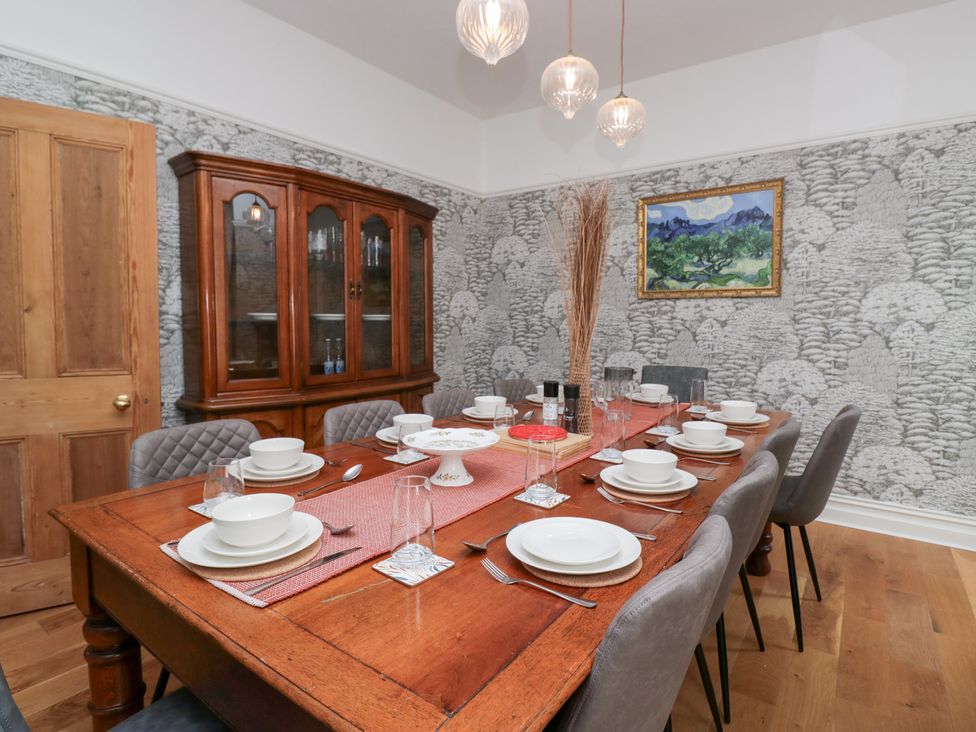 A dining room with a table set for dinner at Sunnycroft in Keswick
