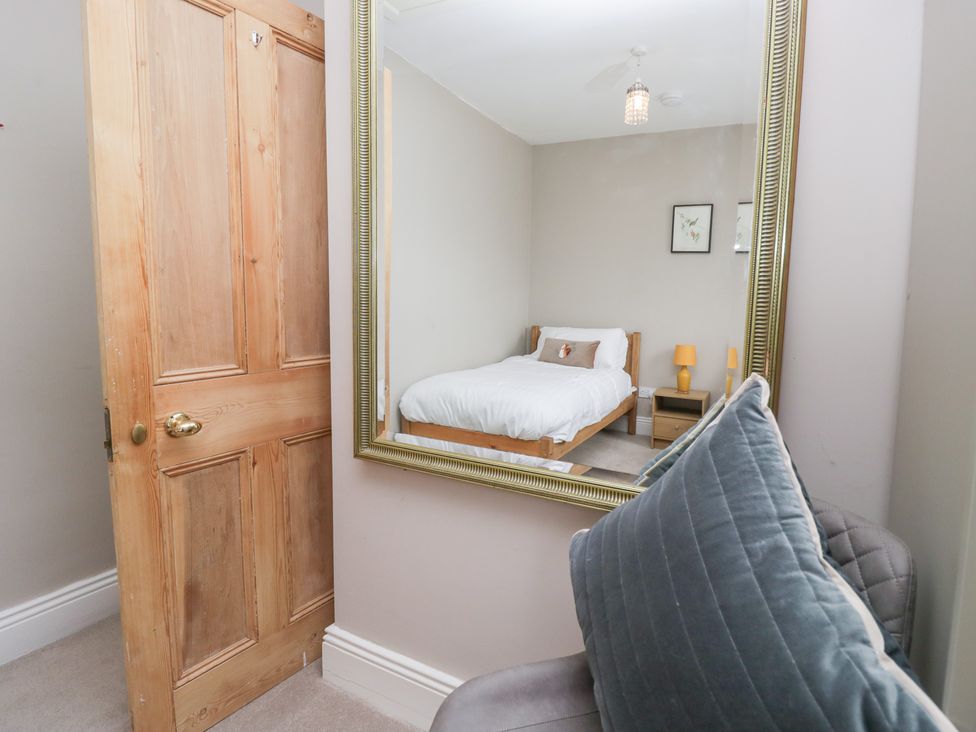 A bedroom with a bed and nightstand at Sunnycroft in Keswick