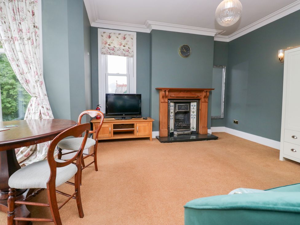 A living room with a television and fireplace at Sunnycroft in Keswick