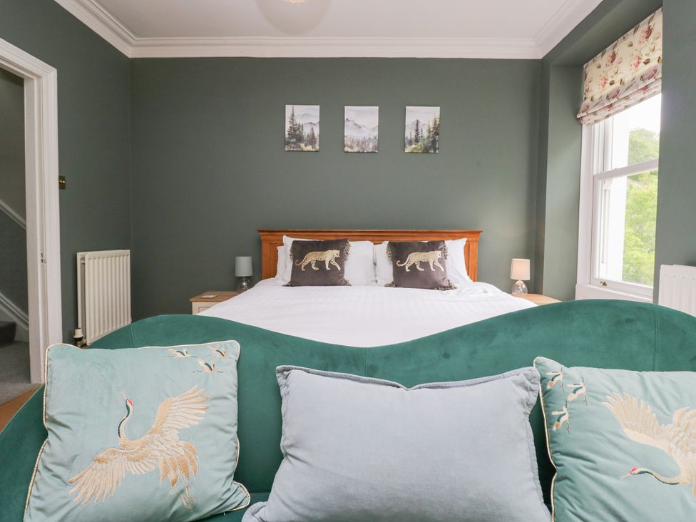 A bedroom with a bed and decorative pillows at Sunnycroft in Keswick