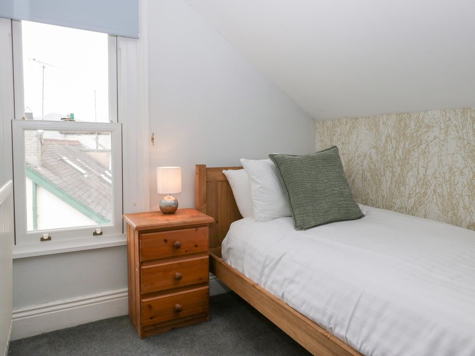 A bedroom with a single bed and a nightstand at Sunnycroft in Keswick