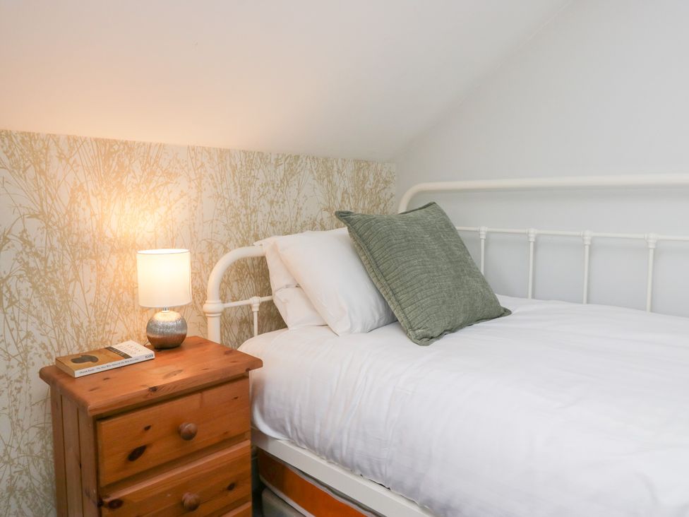 A bedroom with a bed and bedside table at Sunnycroft in Keswick