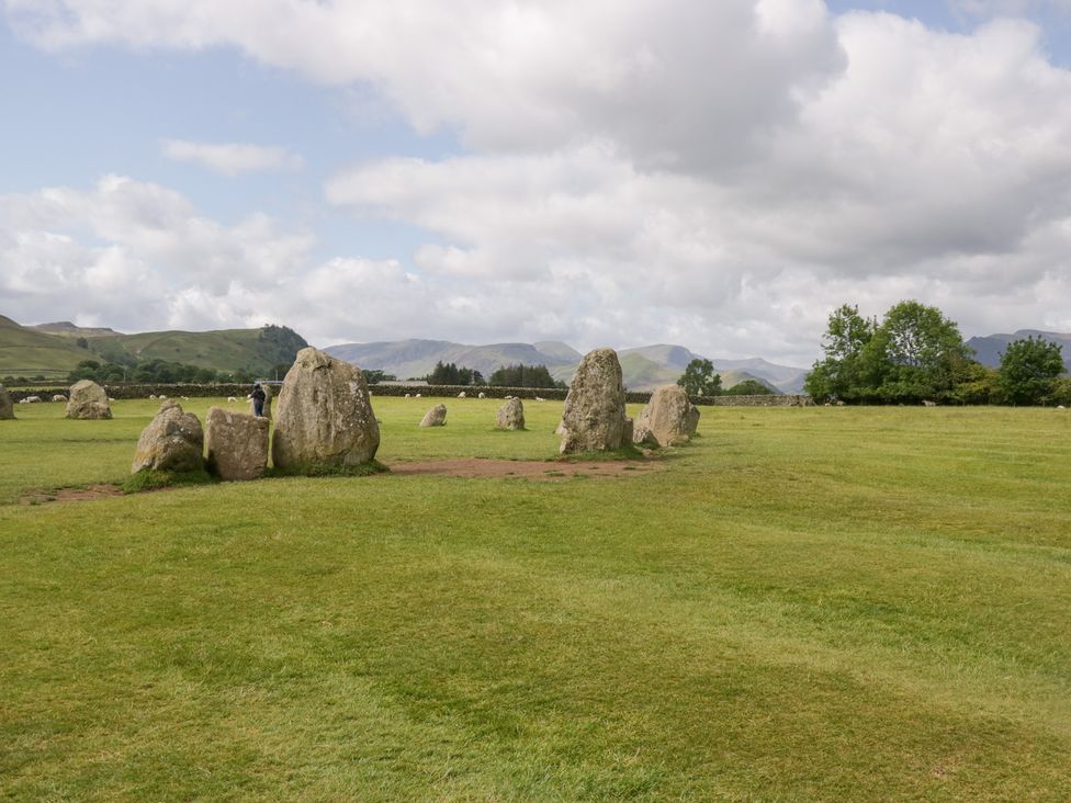 A circle of standing stones in a grassy field at Sunnycroft in Keswick