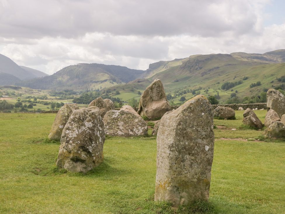Standing stones in a grassy field with mountains in the background at Sunnycroft in Keswick